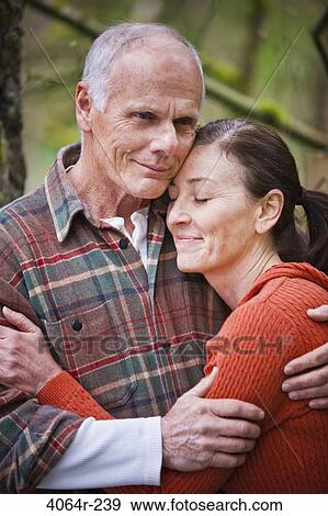 Stock Photo - USA, Washington, Vancouver, Couple embracing outdoors. Fotosearch