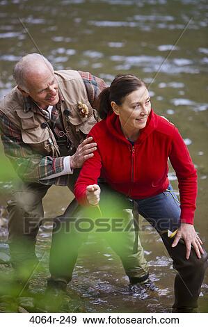 USA, Washington, Vancouver, Couple skipping stones on river View Large Photo Image Stock Photo - USA, Washington, Vancouver, Couple skipping stones on river. Fotosearch