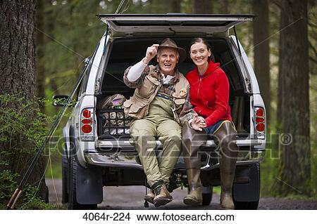 USA, Washington, Vancouver, Portrait of smiling couple sitting in back of car after fishing View Large Photo Image Picture - USA, Washington, Vancouver, Portrait of smiling couple sitting in back of car after fishing. Fotosearch