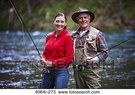 USA, Washington, Vancouver, Portrait of smiling couple fishing in river View Large Photo Image Stock Image - USA, Washington, Vancouver, Portrait of smiling couple fishing in river. Fotosearch