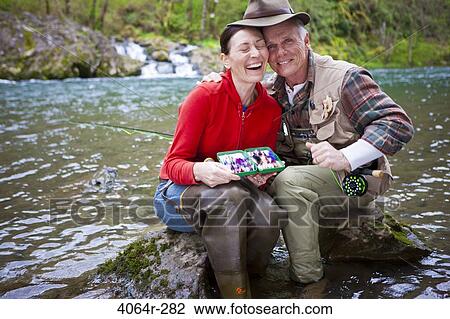 USA, Washington, Vancouver, Portrait of smiling couple fishing in river View Large Photo Image Stock Image - USA, Washington, Vancouver, Portrait of smiling couple fishing in river. Fotosearch