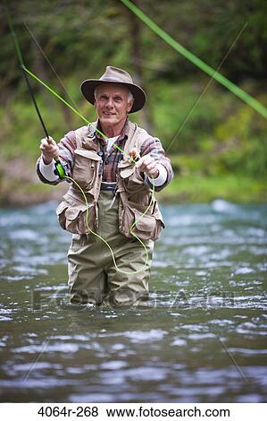 USA, Washington, Vancouver, Portrait of senior man fishing on river View Large Photo Image Stock Photo - USA, Washington, Vancouver, Portrait of senior man fishing on river. Fotosearch