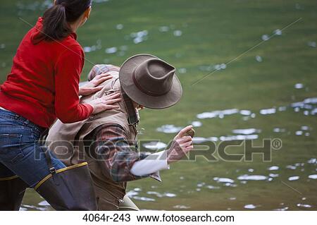 USA, Washington, Vancouver, Rear view of couple skipping stones on river View Large Photo Image Stock Image - USA, Washington, Vancouver, Rear view of couple skipping stones on river. Fotosearch