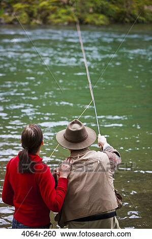 USA, Washington, Vancouver, Rear view of couple fishing in river View Large Photo Image Stock Image - USA, Washington, Vancouver, Rear view of couple fishing in river. Fotosearch