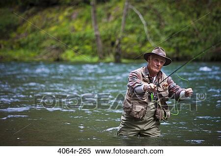 Stock Photography - USA, Washington, Vancouver, Senior man fishing on river. Fotosearch