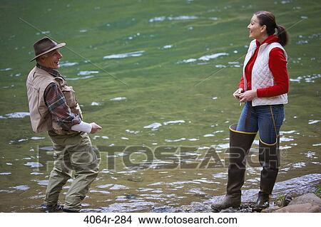 USA, Washington, Vancouver, Smiling couple fishing in river View Large Photo Image Picture - USA, Washington, Vancouver, Smiling couple fishing in river. Fotosearch