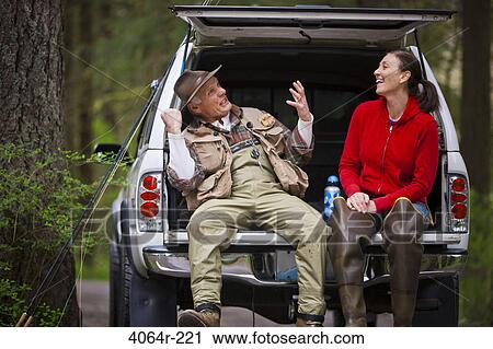USA, Washington, Vancouver, Smiling couple sitting in back of car after fishing View Large Photo Image Stock Image - USA, Washington, Vancouver, Smiling couple sitting in back of car after fishing. Fotosearch