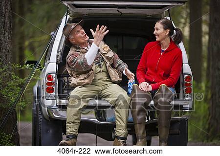 USA, Washington, Vancouver, Smiling couple sitting in back of car after fishing View Large Photo Image Stock Image - USA, Washington, Vancouver, Smiling couple sitting in back of car after fishing. Fotosearch