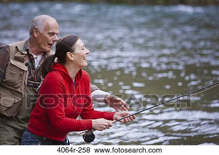 USA, Washington, Vancouver, Smiling couple fishing in river View Large Photo Image Stock Photo - USA, Washington, Vancouver, Smiling couple fishing in river. Fotosearch