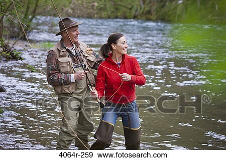 USA, Washington, Vancouver, Smiling couple fishing in river View Large Photo Image Stock Photo - USA, Washington, Vancouver, Smiling couple fishing in river. Fotosearch