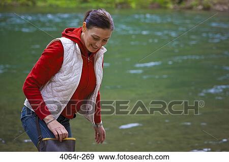 USA, Washington, Vancouver, Smiling woman standing by river View Large Photo Image Stock Photo - USA, Washington, Vancouver, Smiling woman standing by river. Fotosearch