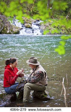 USA, Washington, Vancouver, Smiling couple fishing in river View Large Photo Image Stock Photo - USA, Washington, Vancouver, Smiling couple fishing in river. Fotosearch