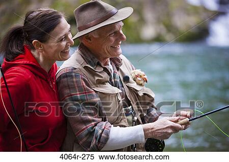 USA, Washington, Vancouver, Smiling couple fishing in river View Large Photo Image Stock Photography - USA, Washington, Vancouver, Smiling couple fishing in river. Fotosearch
