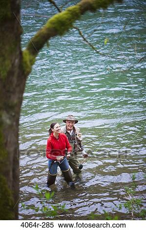 USA, Washington, Vancouver, Smiling couple fishing in river View Large Photo Image Stock Photography - USA, Washington, Vancouver, Smiling couple fishing in river. Fotosearch