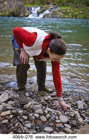 USA, Washington, Vancouver, Woman skipping stones in river View Large Photo Image Stock Photograph - USA, Washington, Vancouver, Woman skipping stones in river. Fotosearch