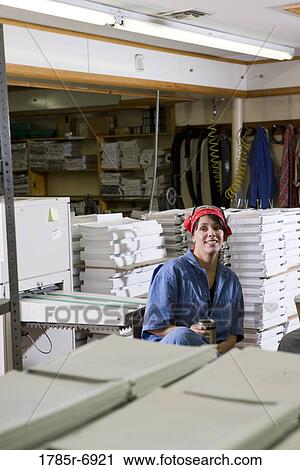 View of a woman sitting down during a coffee break while working in a warehouse View Large Photo Image Stock Image - View of a woman sitting down during a coffee break while working in a warehouse. Fotosearch