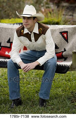 View of a young man in Tex-Mex costume sitting on a swing View Large Photo Image Stock Photo - View of a young man in Tex-Mex costume sitting on a swing. Fotosearch