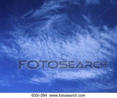 Wispy clouds in a blue sky View Large Photo Image Picture - Wispy clouds in a blue sky. Fotosearch