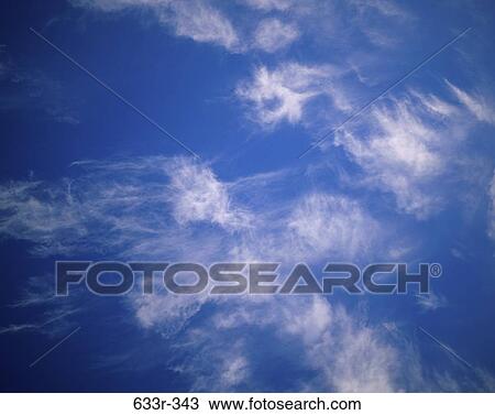 Wispy clouds in a blue sky View Large Photo Image Stock Image - Wispy clouds in a blue sky. Fotosearch