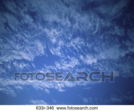 Stock Photograph - Wispy clouds in a blue sky. Fotosearch
