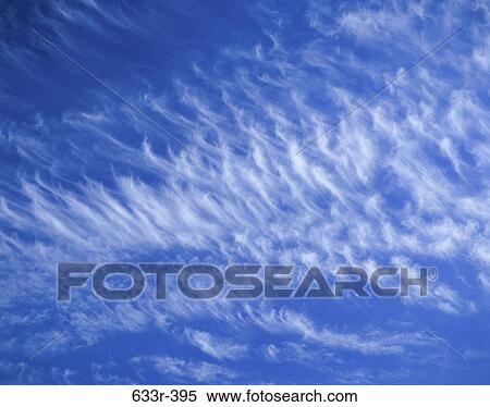Wispy clouds in a blue sky View Large Photo Image Stock Photography - Wispy clouds in a blue sky. Fotosearch