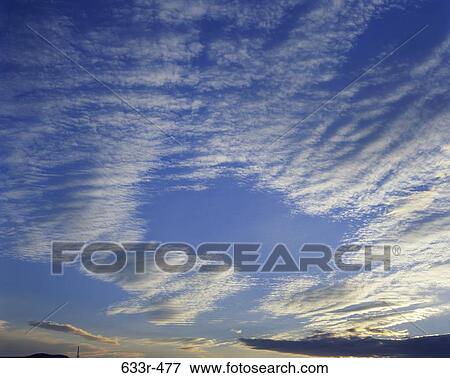 Wispy clouds in the sky View Large Photo Image Stock Photo - Wispy clouds in the sky. Fotosearch