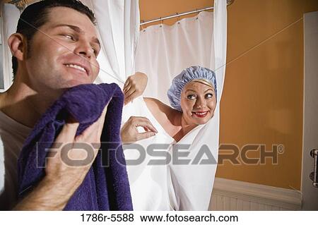 Woman in showercap peeking at man with towel View Large Photo Image Stock Photo - Woman in showercap peeking at man with towel. Fotosearch