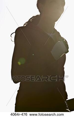 Woman jogging, backlit by sun View Large Photo Image Stock Photograph - Woman jogging, backlit by sun. Fotosearch