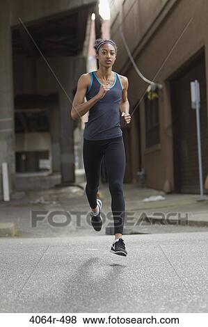 Woman jogging in street View Large Photo Image Stock Photo - Woman jogging in street. Fotosearch