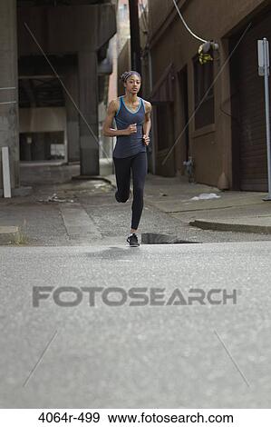 Stock Photo - Woman jogging in street. Fotosearch