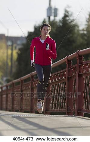 Woman jogging on bridge View Large Photo Image Stock Image - Woman jogging on bridge. Fotosearch