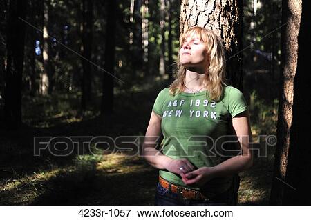 Woman leaning against tree with eyes closed in forest, Bavaria, Germany View Large Photo Image Stock Photo - Woman leaning against tree with eyes closed in forest, Bavaria, Germany. Fotosearch