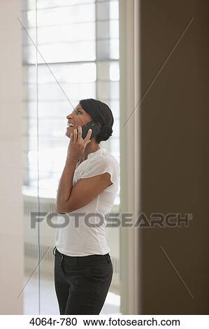 Woman on phone in office View Large Photo Image Stock Image - Woman on phone in office. Fotosearch