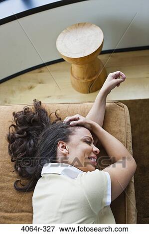 Woman relaxing on couch View Large Photo Image Stock Photo - Woman relaxing on couch. Fotosearch
