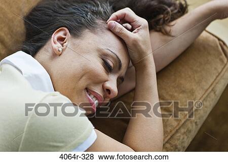Woman relaxing on couch View Large Photo Image Stock Photo - Woman relaxing on couch. Fotosearch