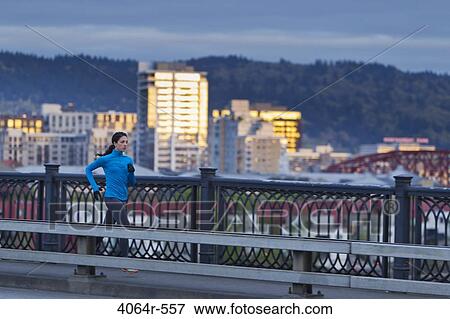 Woman running along bridge View Large Photo Image Stock Photo - Woman running along bridge. Fotosearch