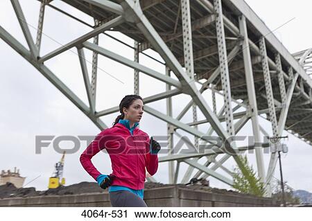 Woman running underneath bridge View Large Photo Image Stock Image - Woman running underneath bridge. Fotosearch