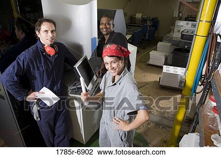Workers being trained to use a piece of machinery with computer controls View Large Photo Image Stock Image - Workers being trained to use a piece of machinery with computer controls. Fotosearch