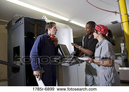 Workers being trained to use a piece of machinery with computer controls View Large Photo Image Stock Photo - Workers being trained to use a piece of machinery with computer controls. Fotosearch