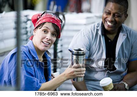 Workers in coveralls having a coffee break View Large Photo Image Stock Image - Workers in coveralls having a coffee break. Fotosearch