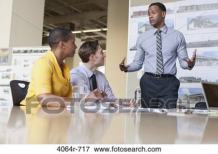 Stock Photo - Workgroup collaborating on project at office. Fotosearch
