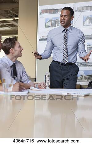 Stock Photograph - Workgroup collaborating on project at office. Fotosearch
