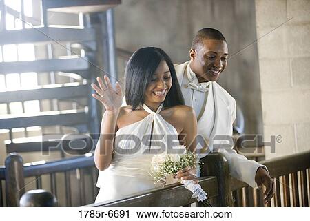 Young bride and groom looking down over balcony railing View Large Photo Image Stock Image - Young bride and groom looking down over balcony railing. Fotosearch