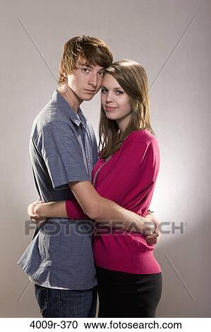 Young couple embracing each other View Large Photo Image Stock Image - Young couple embracing each other. Fotosearch