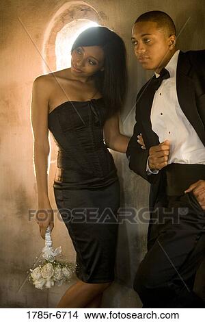 Young couple in formal attire arm in arm View Large Photo Image Picture - Young couple in formal attire arm in arm. Fotosearch