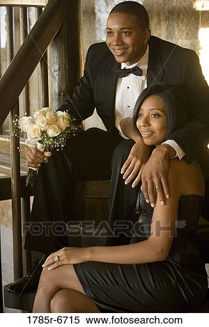 Young couple in formal attire sitting on stairs View Large Photo Image Stock Photography - Young couple in formal attire sitting on stairs. Fotosearch