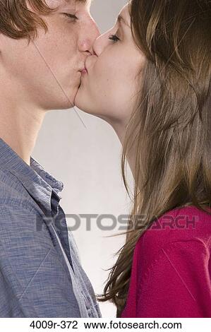 Stock Image - Young couple kissing each other. Fotosearch