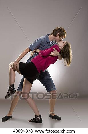Stock Photo - Young couple kissing each other. Fotosearch