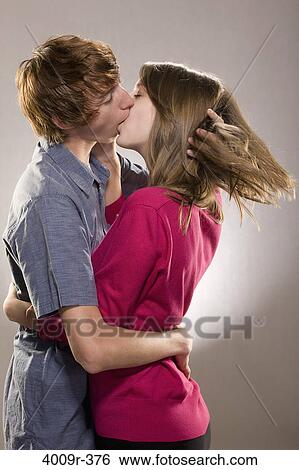 Young couple kissing each other View Large Photo Image Stock Photograph - Young couple kissing each other. Fotosearch