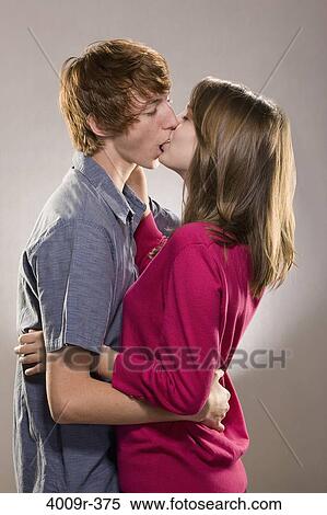 Young couple kissing each other View Large Photo Image Stock Photography - Young couple kissing each other. Fotosearch